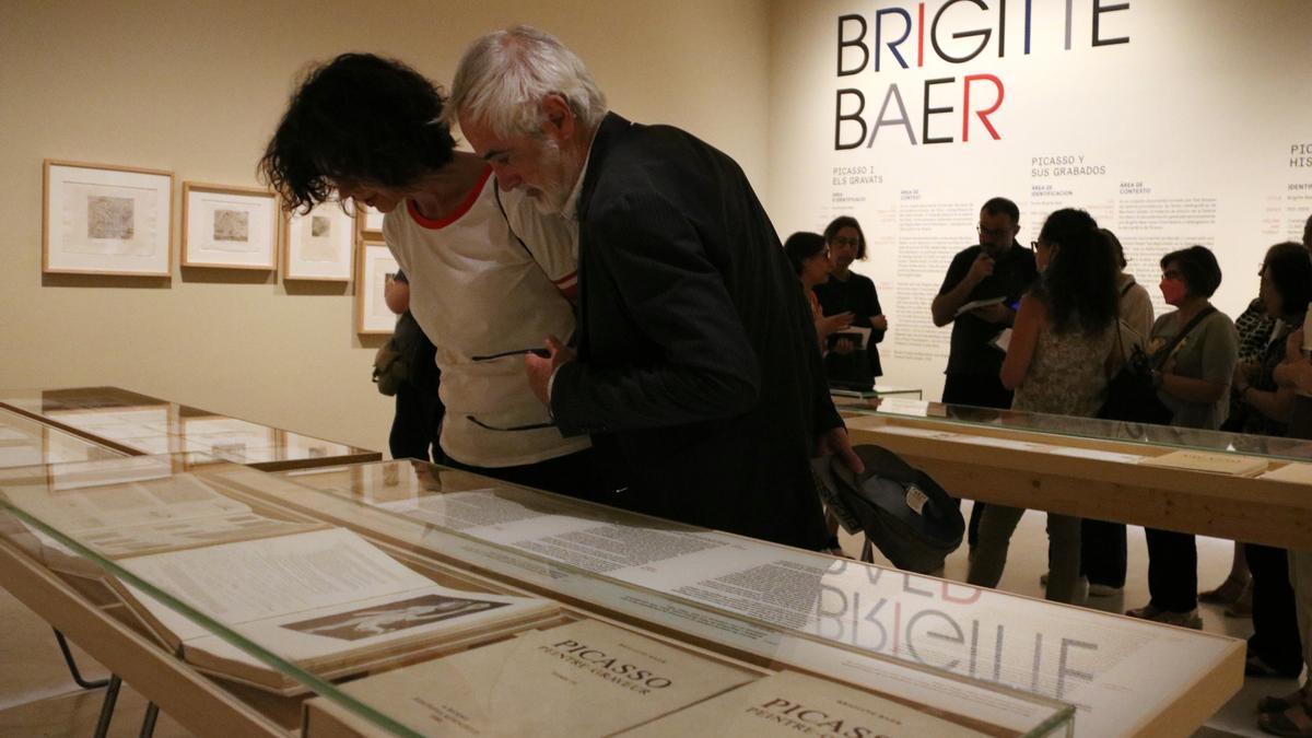 Diverses persones observen documents de l&#039;arxiu de Brigitte Baer sobre els gravats de Picasso, al museu del pintor a Barcelona