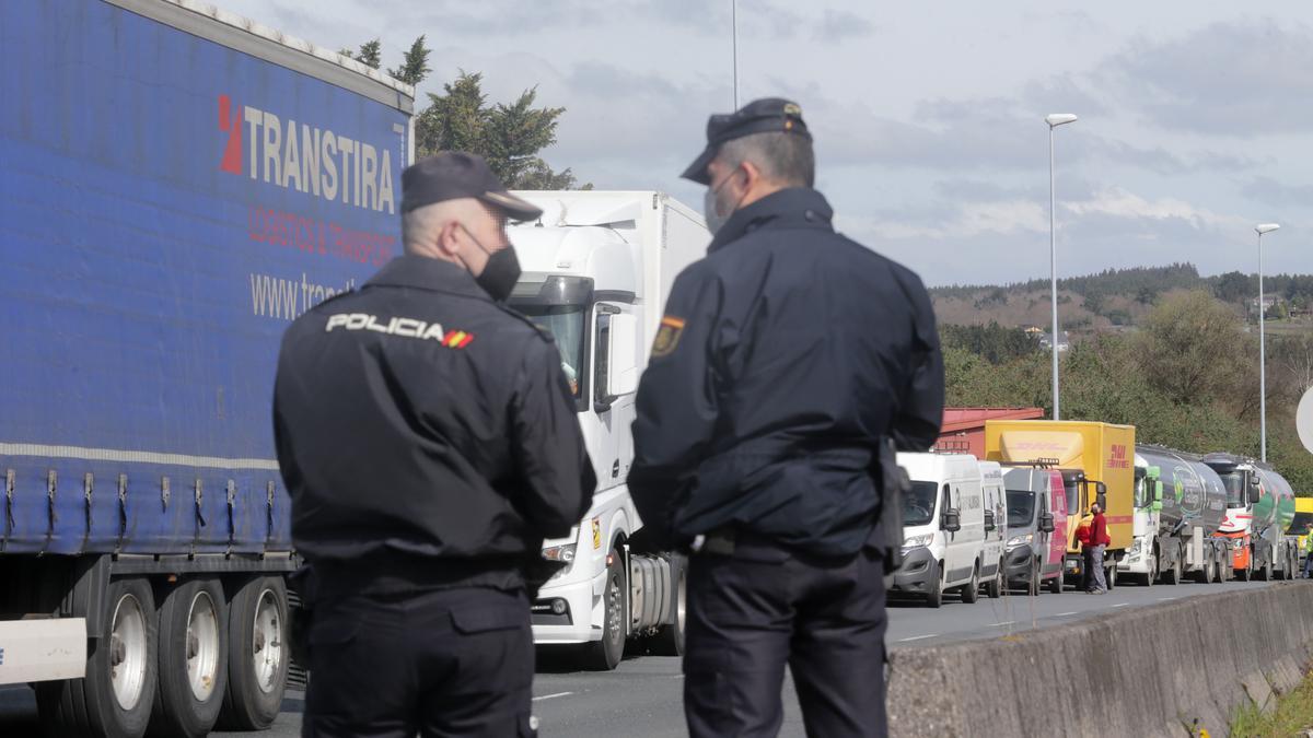 Agentes de la Policía Nacional observan los camiones parados en Lugo.