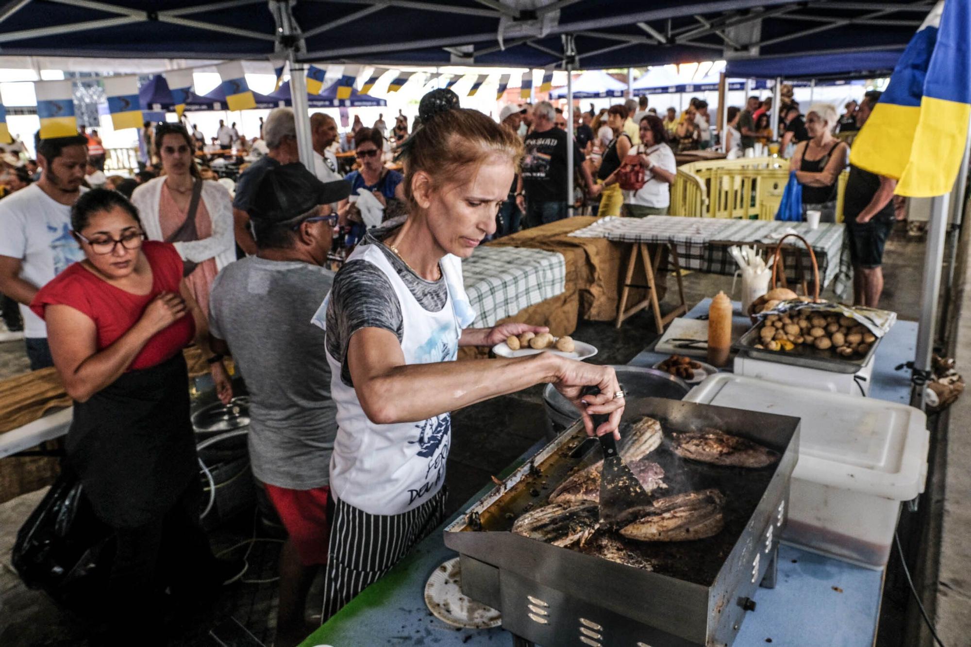 Una participante en la Feria del Atún pasa a la plancha unos lomos de este túnido.