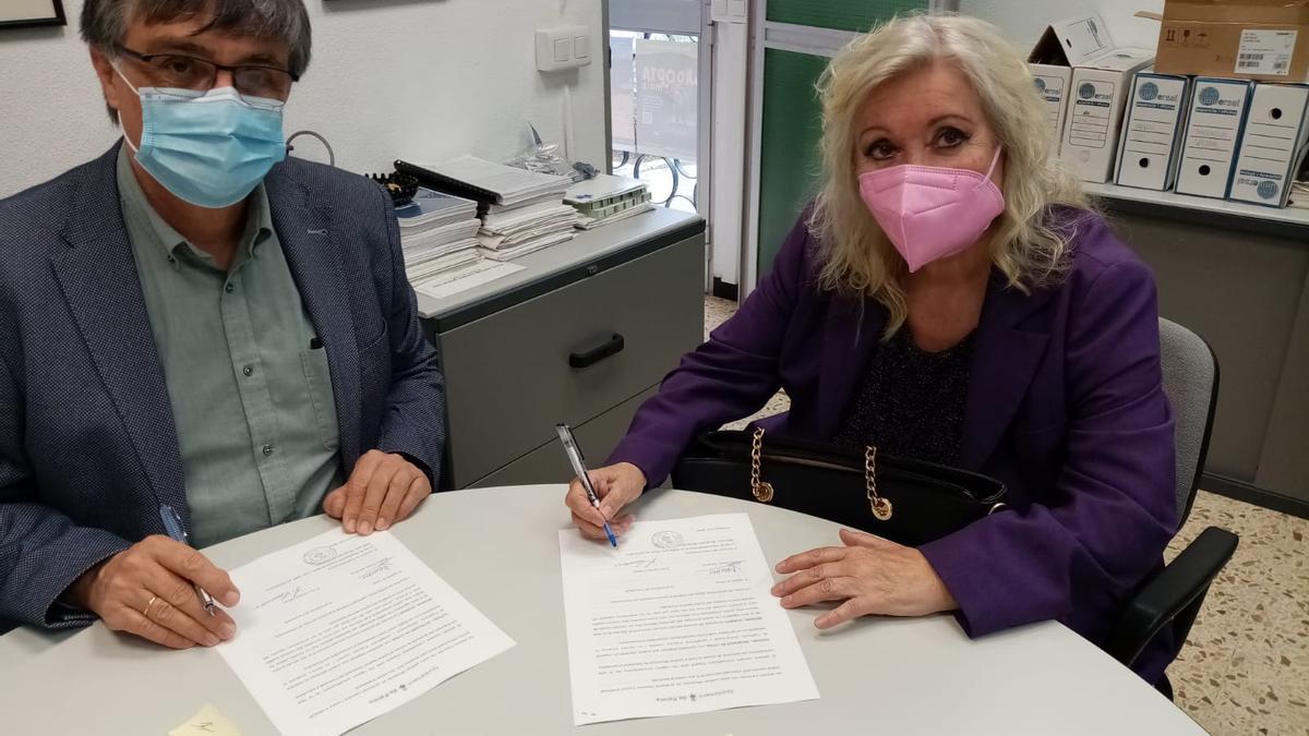 El teniente de alcalde de Bienestar Animal, Ramon Perpinyà, firma el convenio con Lynda  Commons, en nombre de Peluditos de Son Reus.