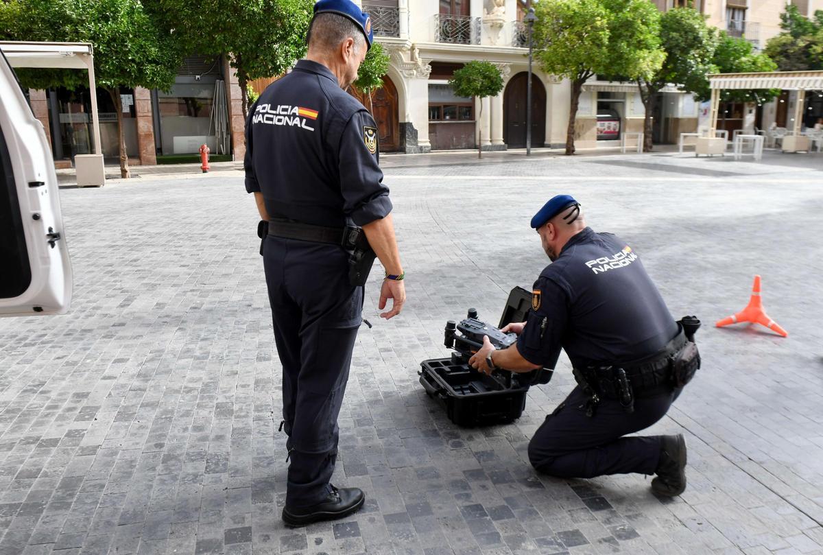 Corral (de pie) y García preparan el equipo para echar a volar un dron en Belluga.