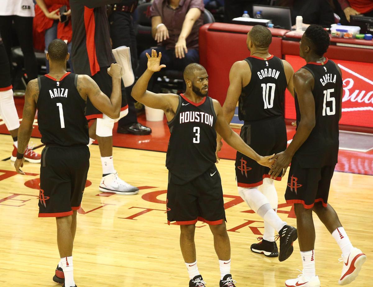 May 16, 2018; Houston, TX, USA; Houston Rockets guard Chris Paul (3) reacts with forward Trevor Ariza (1) guard Eric Gordon (10) and center Clint Capela (15) against the Golden State Warriors during the second half in game two of the Western conference finals of the 2018 NBA Playoffs at Toyota Center. Mandatory Credit: Troy Taormina-USA TODAY Sports