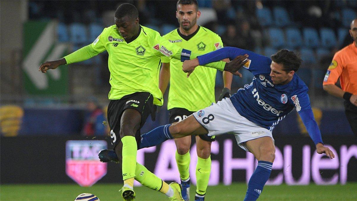 Nicolas Pépé (izquierda) pelea el balón con Jonas Martín durante el Estrasburgo-Lille de la Ligue 1 2018/19