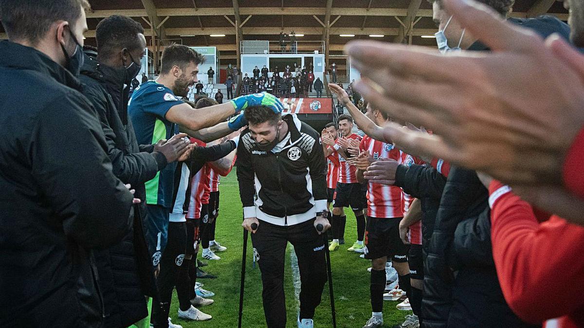 Los jugadores hacen el pasillo a sus compañeros lesionados.