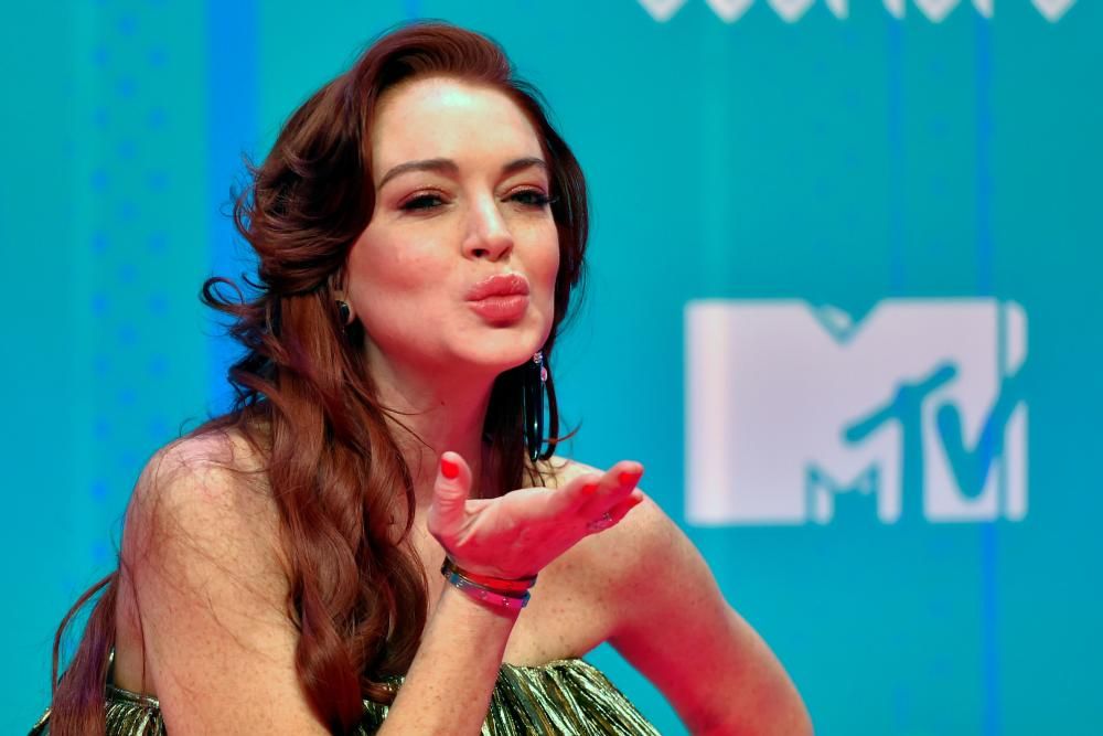 US actress Lindsay Lohan poses on the red carpet ahead of the MTV Europe Music Awards at the Bizkaia Arena in the northern Spanish city of Bilbao on November 4, 2018. (Photo by ANDER GILLENEA / AFP)