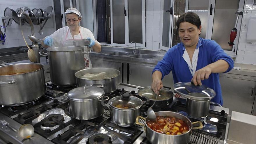 Voluntarios cocinan, esta mañana, el menú de Antroxu en la Cocina Económica