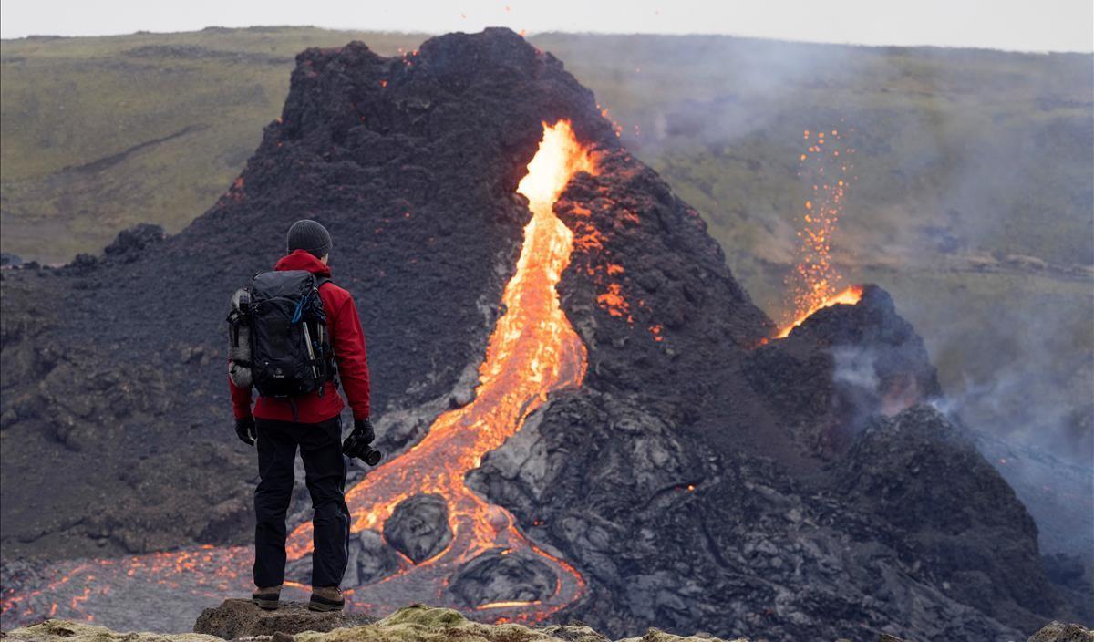 A person stands in front of the volcanic site on the Reykjanes Peninsula following Friday s eruption in Iceland  March 21  2021  Picture taken March 