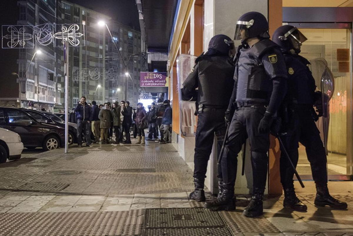 Membres del Cos Nacional de Policia als disturbis que han provocat centenars de persones participants en una protesta veïnal al barri de Gamonal, a Burgos.