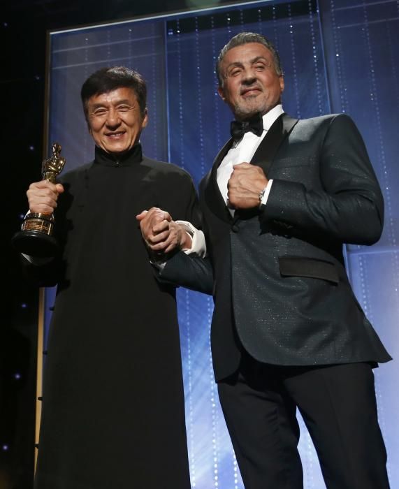 Actor Chan is congratulated by fellow actor ...