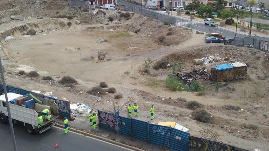 Operarios de Limpieza recogen basura en el solar del Gran Guanarteme el pasado jueves.