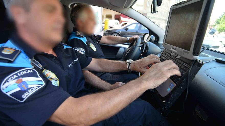 Un policía maneja el ordenador, colocado ante el airbag. // G. S.