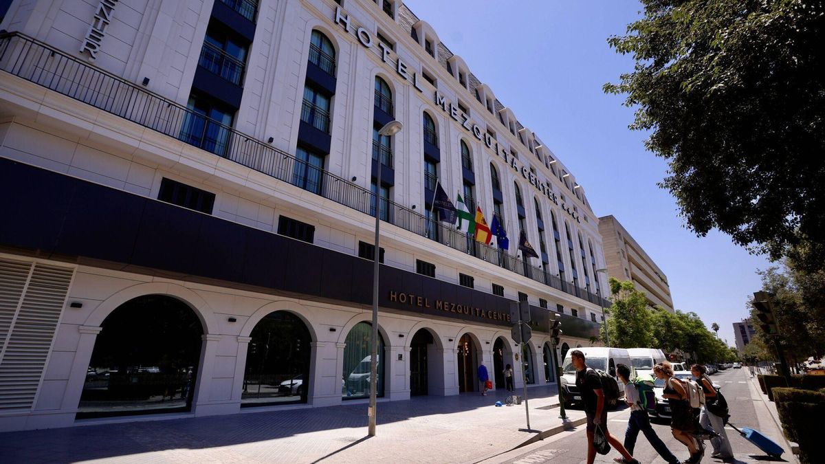 Un grupo de turistas cruza el paso de peatones para acceder al hotel Mezquita Center de Córdoba, hoy.
