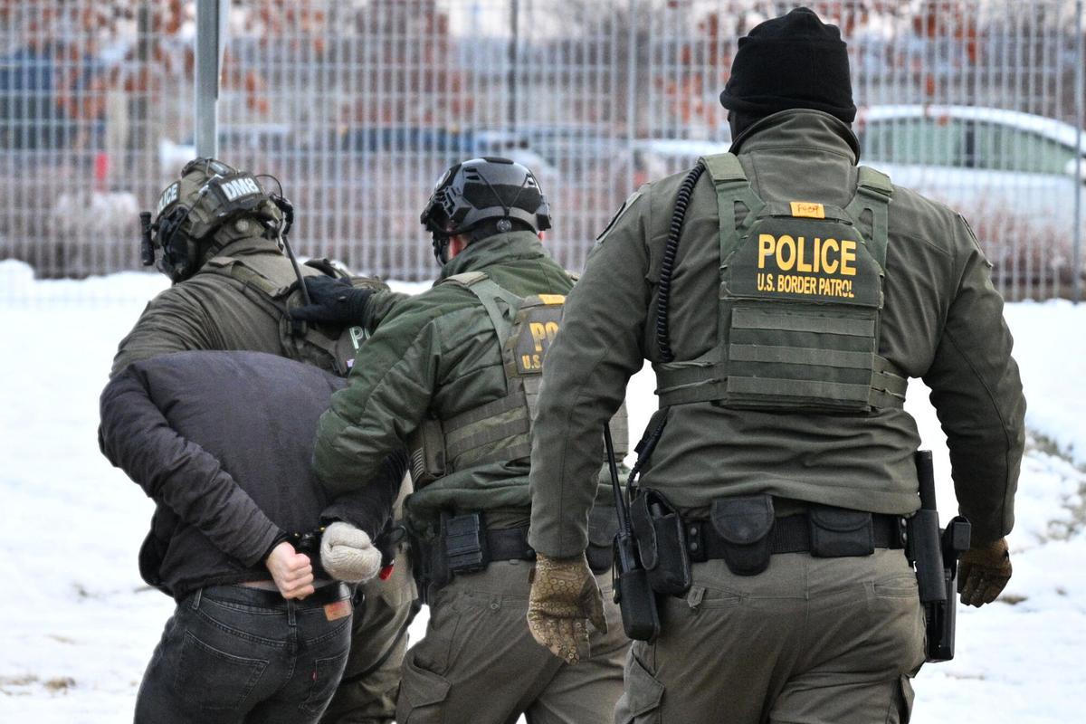 Federal agents confront protesters outside the Bishop Henry Whipple Federal Building, Thursday, Jan. 8, 2026, in Minneapolis, Minn. (AP Photo/Tom Baker)