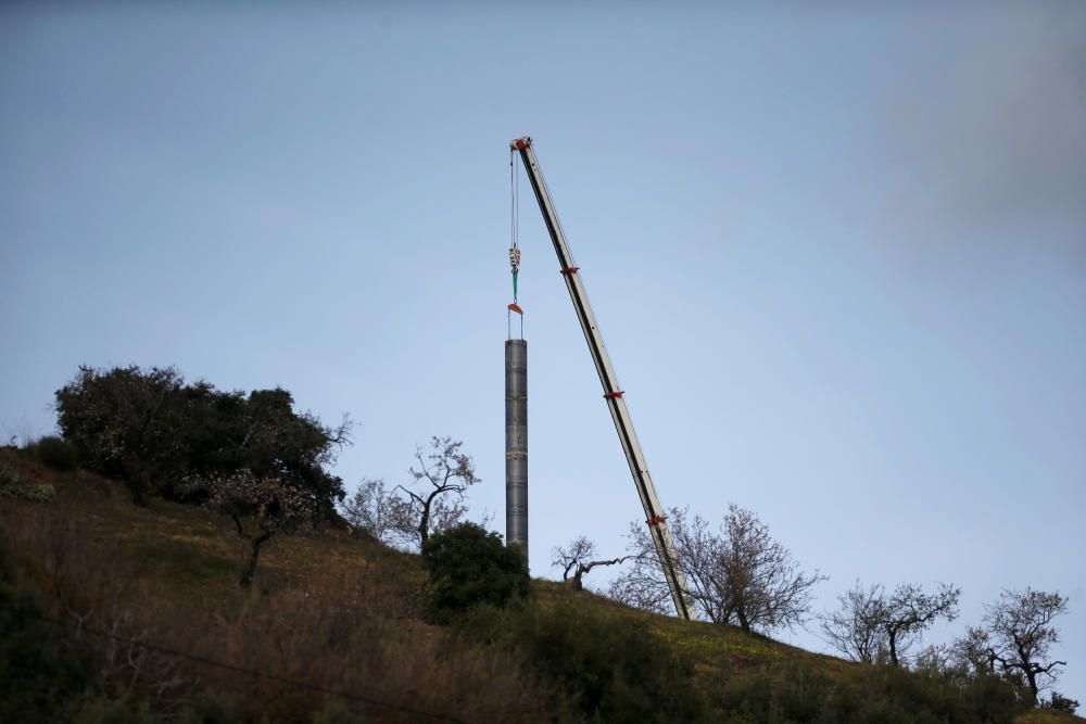 A crane removes steel tubes after failing to ...