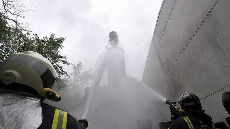 Los bomberos actuando para sofocar el incendio.