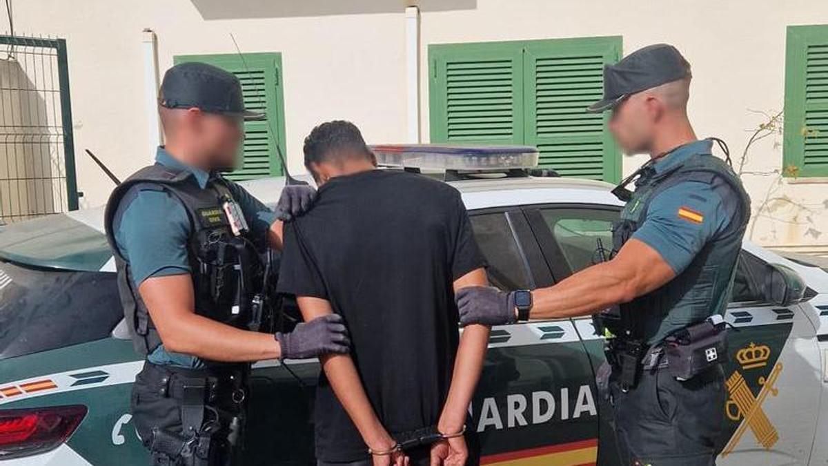 Agentes de la Guardia Civil custodian al detenido por el intendo de homicidio en Cala Rajada.