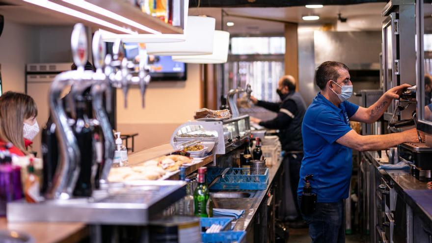 n trabajador prepara un café en un bar de Vitoria.