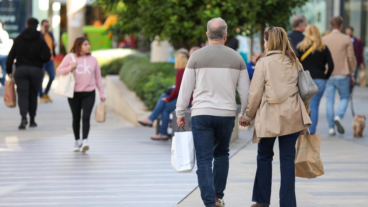 Una pareja pasea de la mano.