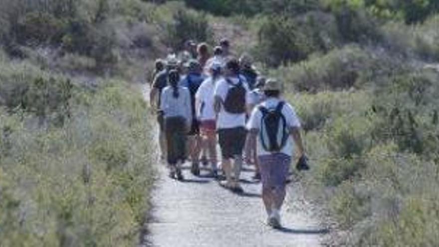 Un grupo de excursionistas, en una visita reivindicativa de defensa del islote, de camino al faro.