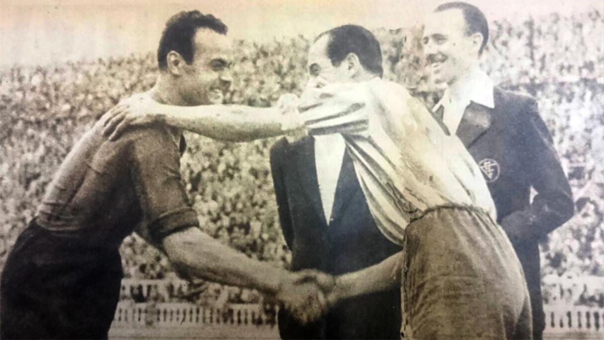 Los capitanes del Barça, el gerundense Curta y del Girona, Camps, se saludan antes del inicio del partido copero, bajo la mirada del árbitro Álvarez Pérez, en un Les Corts casi lleno