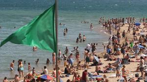 La bandera verde ondea en una playa de la Barceloneta.