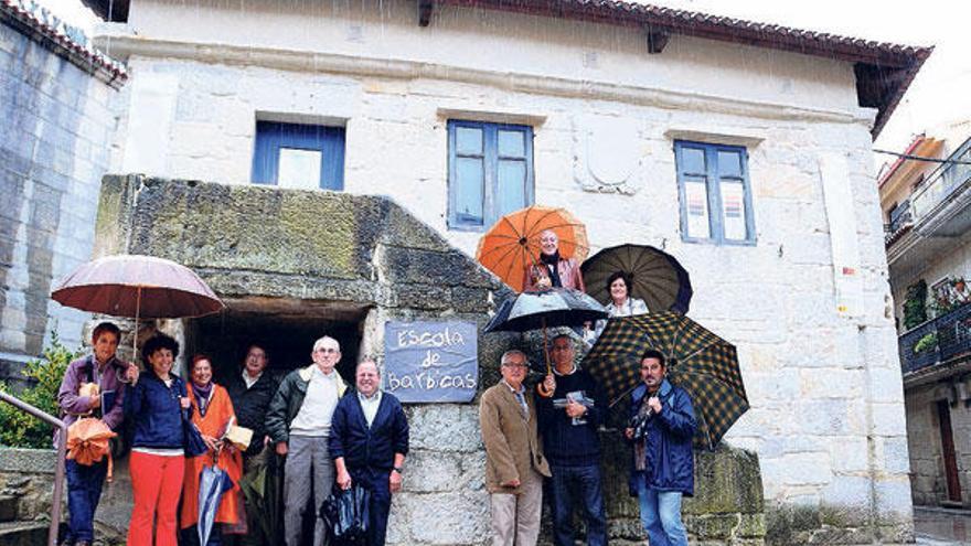 Os integrantes da Asociación Cultural A Cepa diante da antiga Escola de Barbicas.  // G. Núñez