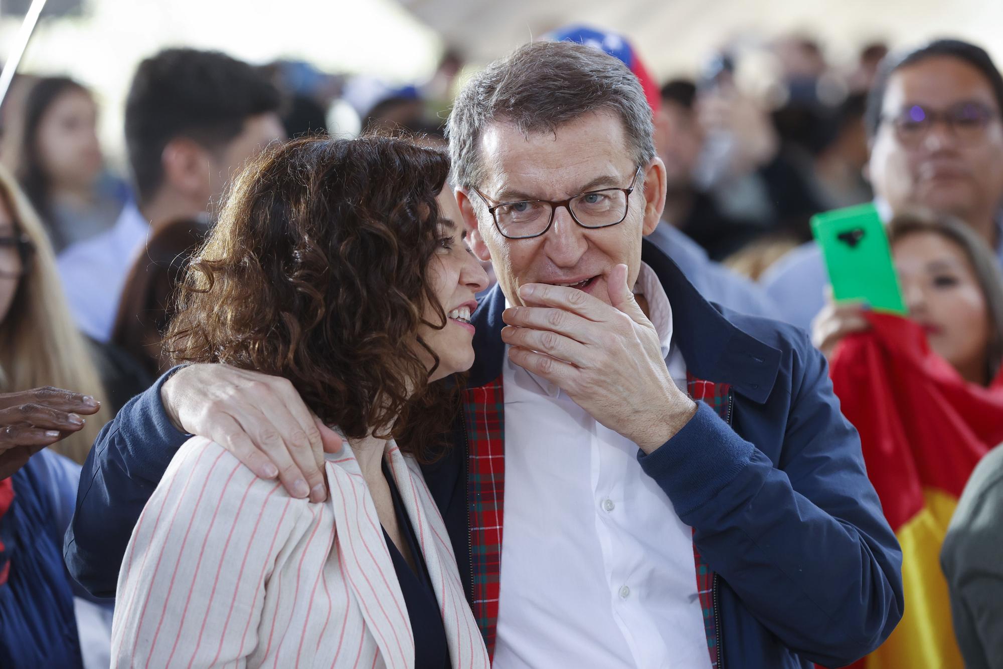 El presidente del PP, Alberto Núñez Feijóo, conversa con la presidenta madrileña, Isabel Díaz Ayuso, en un acto del PP en Madrid.