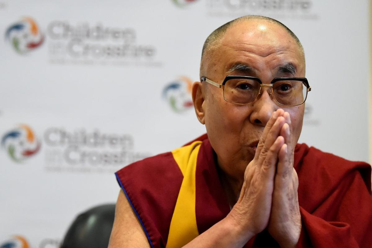 FILE PHOTO: Tibetan spiritual leader the Dalai Lama, Patron of Children in Crossfire, gestures during a press conference in Londonderry, Northern Ireland September 11, 2017. REUTERS/Clodagh Kilcoyne/File Photo