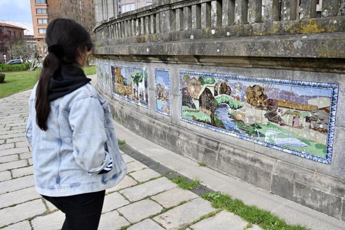 Una joven contempla los azulejos, que adornan la Alameda desde 1927.   | // RAFA VÁZQUEZ