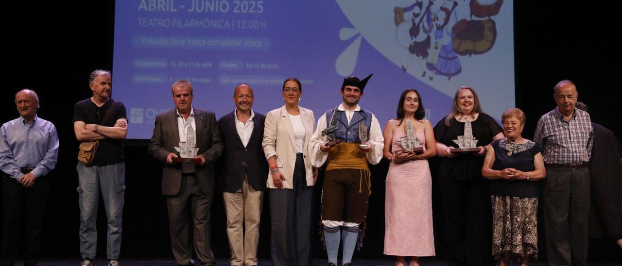 Por la izquierda, Alfonso Sánchez Peña (presidente del jurado), Gustavo Eguren (vocal), Celestino Rozada, Vicente Prado, Covadonga Díaz, el gaitero Diego Fernández, Marina Carbajosa, Lorena Corripio y los miembros del jurado Jesusa «Chucha de Nembra» Fernández y Pedro Rodríguez Cortés. | FERNANDO RODRÍGUEZ