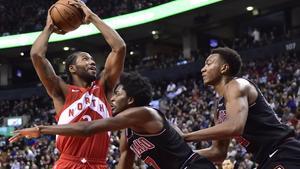 Toronto Raptors forward Kawhi Leonard  2  goes to the net against Chicago Bulls forward Justin Holiday  7  and forward Wendell Carter Jr   34  during second-half NBA basketball game action in Toronto  Ontario.  Frank Gunn The Canadian Press via AP 