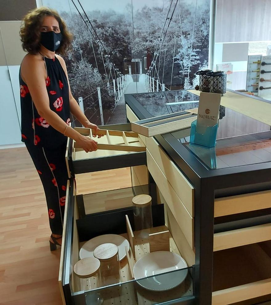 Lara Lemos, socia de Herrajes Formo-3, muestra equipamiento de mobiliario en madera fabricado en A Estrada bajo la marca Nemat.