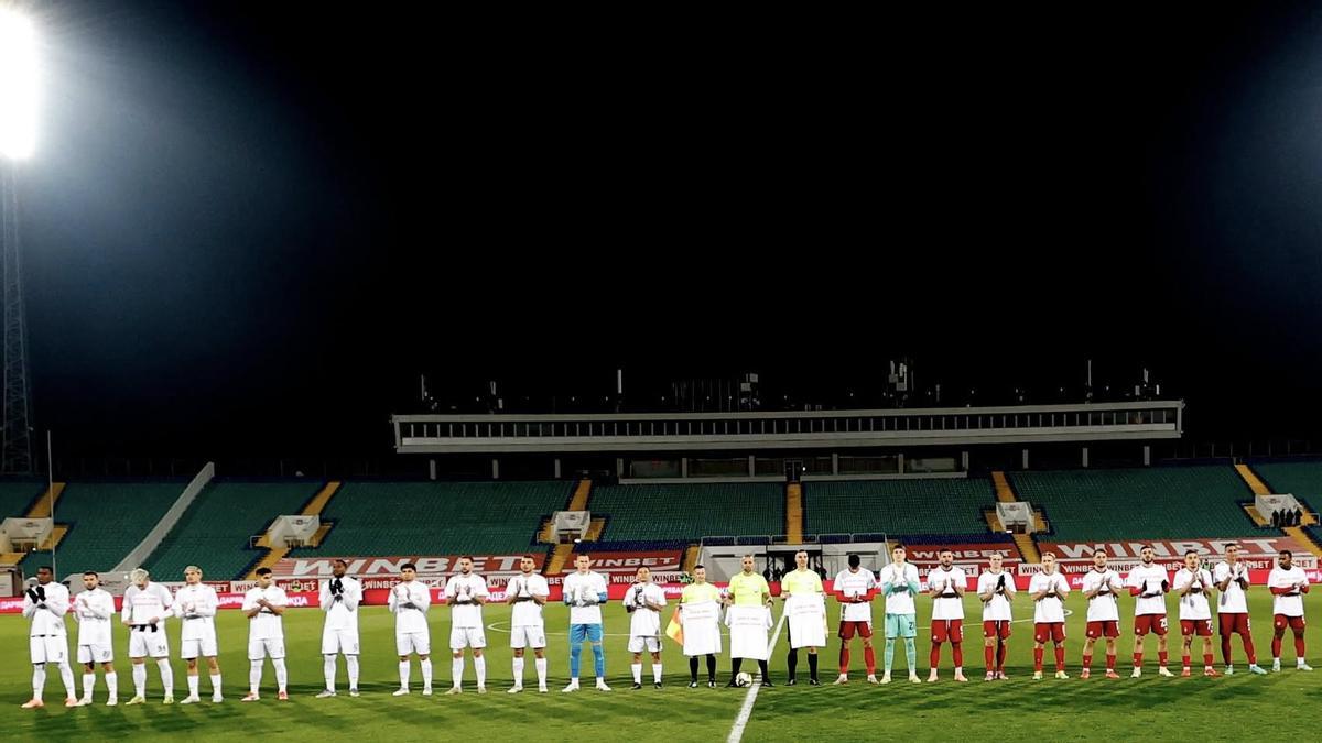Los jugadores de ambos equipos, antes del comienzo del encuentro, que luego se detuvo en el minuto 9