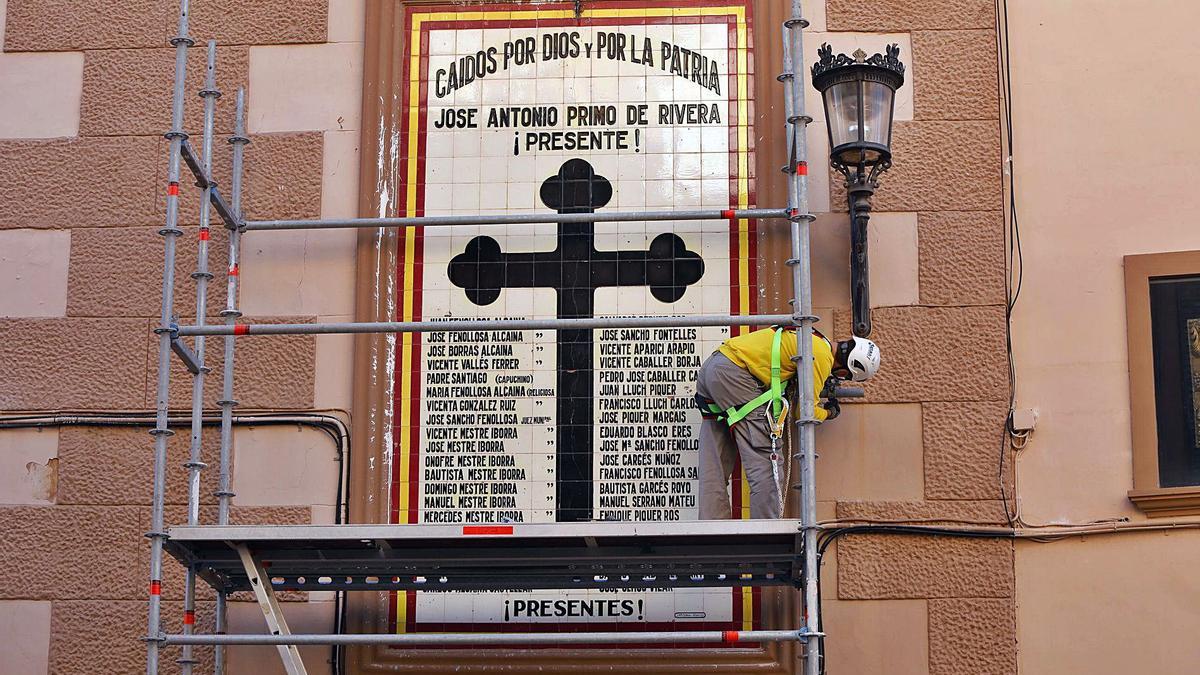 Uno de los operarios ultima el montaje del andamio para iniciar los trabajos de retirada del mural de los «caídos». | M.A. MONTESINOS