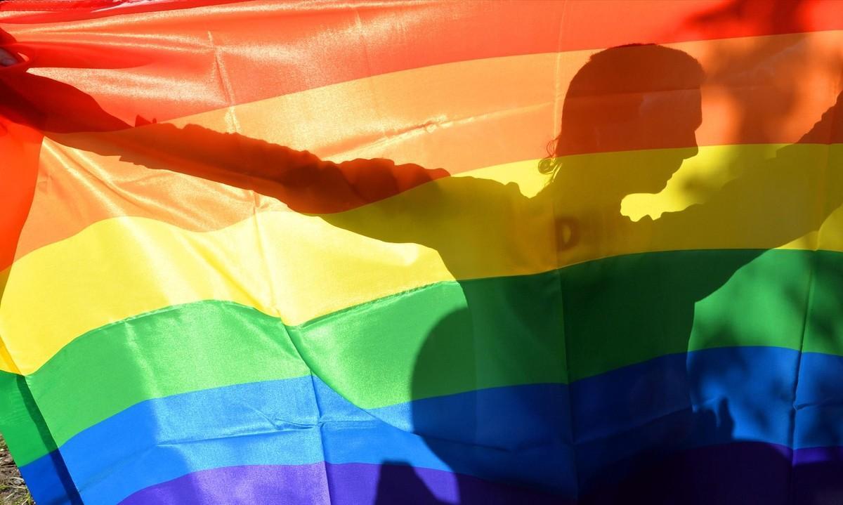 nnavarro22522426 an activist s silhouette is seen through a rainbow flag duri161028173543