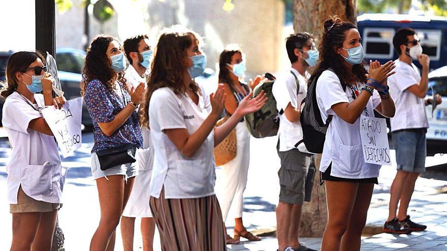 Un grupo del colectivo MIR, en huelga indefinida, protesta ayer en el exterior de la sede de la Conselleria de Sanidad.