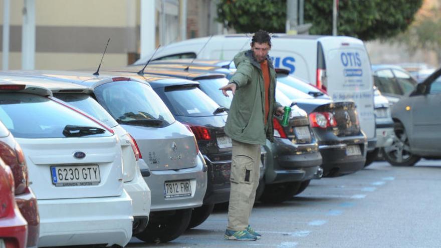 Un gorrilla da instrucciones a un conductor para que estacione su vehículo en una calle de Murcia.