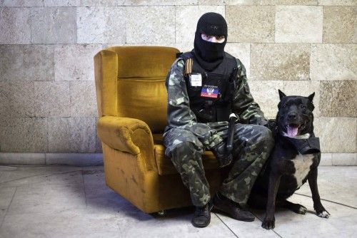 A masked pro-Russian protester poses inside a regional government building in Donetsk