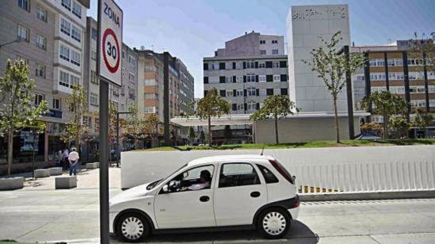 Un vehículo pasa ante una señal de Zona 30 en el Agra do Orzán.