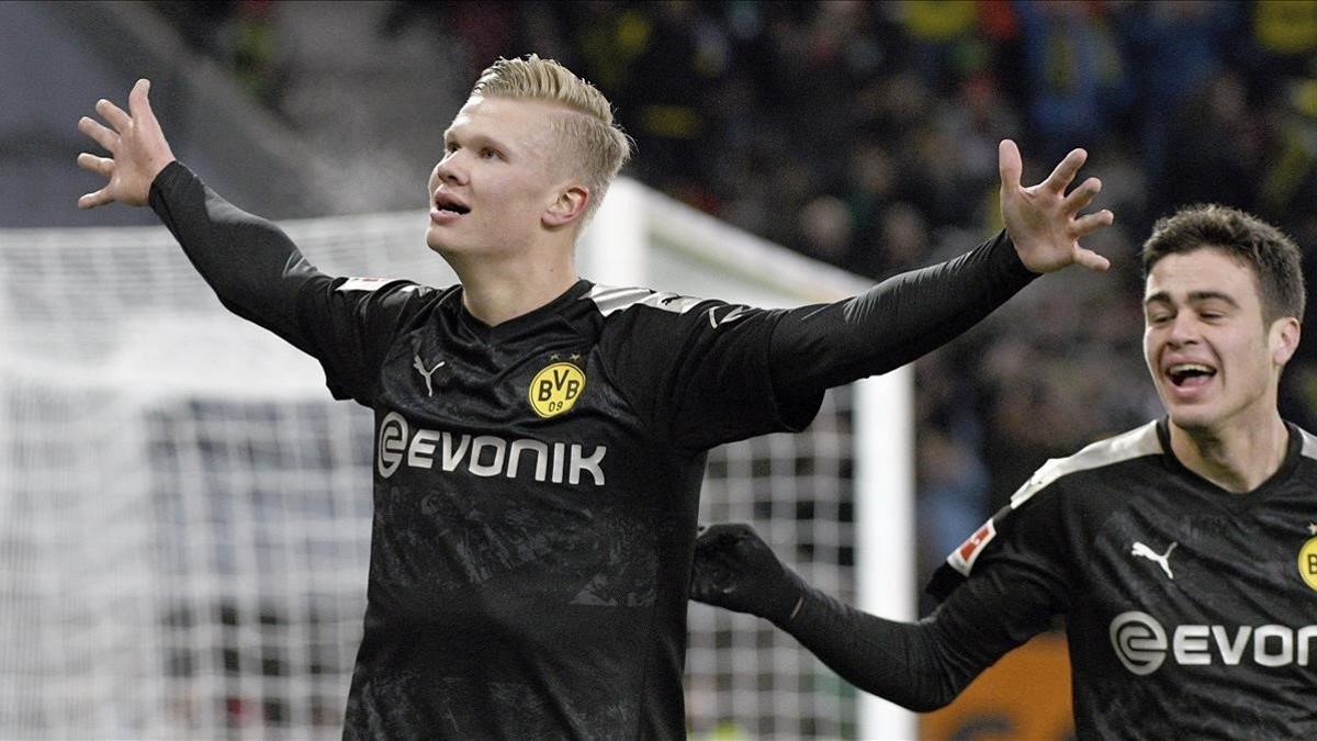 Erling Haaland celebra su tercer gol al Augsburgo en su debut liguero con el Dortmund.