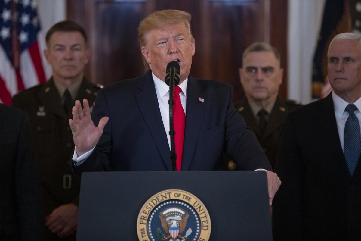 President Donald Trump addresses the nation from the White House on the ballistic missile strike that Iran launched against Iraqi air bases housing U.S. troops, Wednesday, Jan. 8, 2020, in Washington, as Chairman of the Joint Chiefs of Staff Gen. Mark Milley, and Vice President Mike Pence, and others look on. (AP Photo/ Evan Vucci)