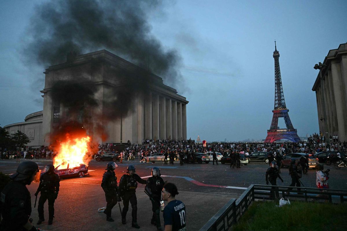 Paris Saint-Germain fans celebrating their team's UEFA Champions League victory at the Place du Trocadero across from the Eiffel Tower in Paris