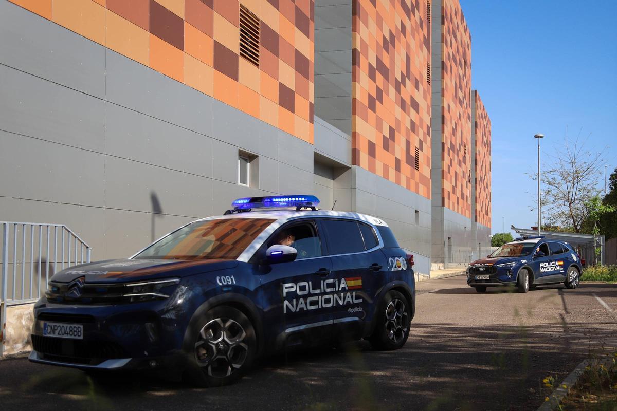 Dos coches policiales acceden a los juzgados de Badajoz para llevar ante el juez a los dos detenidos por el tiroteo ocurrido el día 24 de abril.