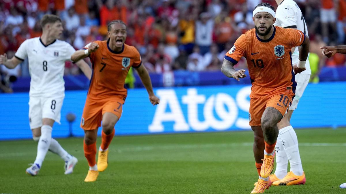 Memphis Depay corre a celebrar su gol a Austria perseguido de Xavi Simons.