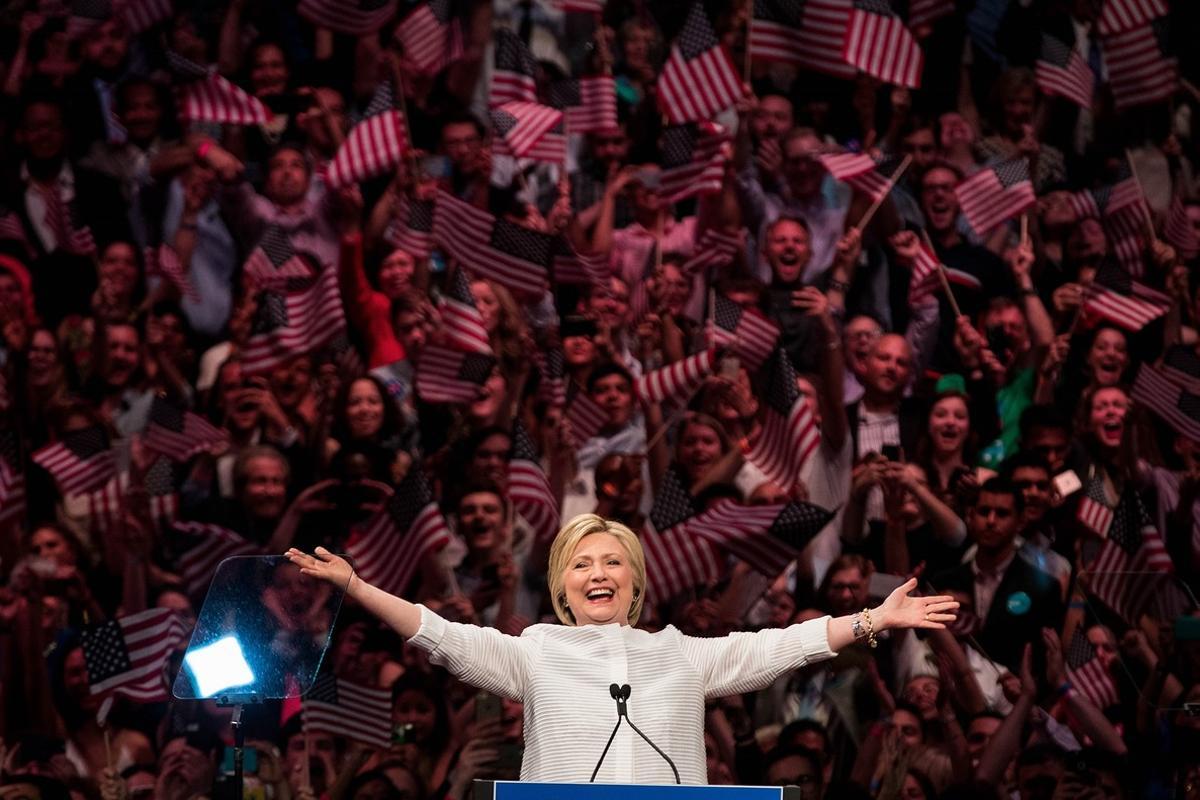 NEW YORK, NY - JUNE 7: Democratic presidential candidate Hillary Clinton arrives onstage during a primary night rally at the Duggal Greenhouse in the Brooklyn Navy Yard, June 7, 2016 in the Brooklyn borough of New York City. Clinton has secured enough delegates and commitments from superdelegates to become the Democratic Party’s presumptive presidential nominee. She will become the first woman in U.S. history to secure the presidential nomination of one of the country’s two major political parties.   Drew Angerer/Getty Images/AFP