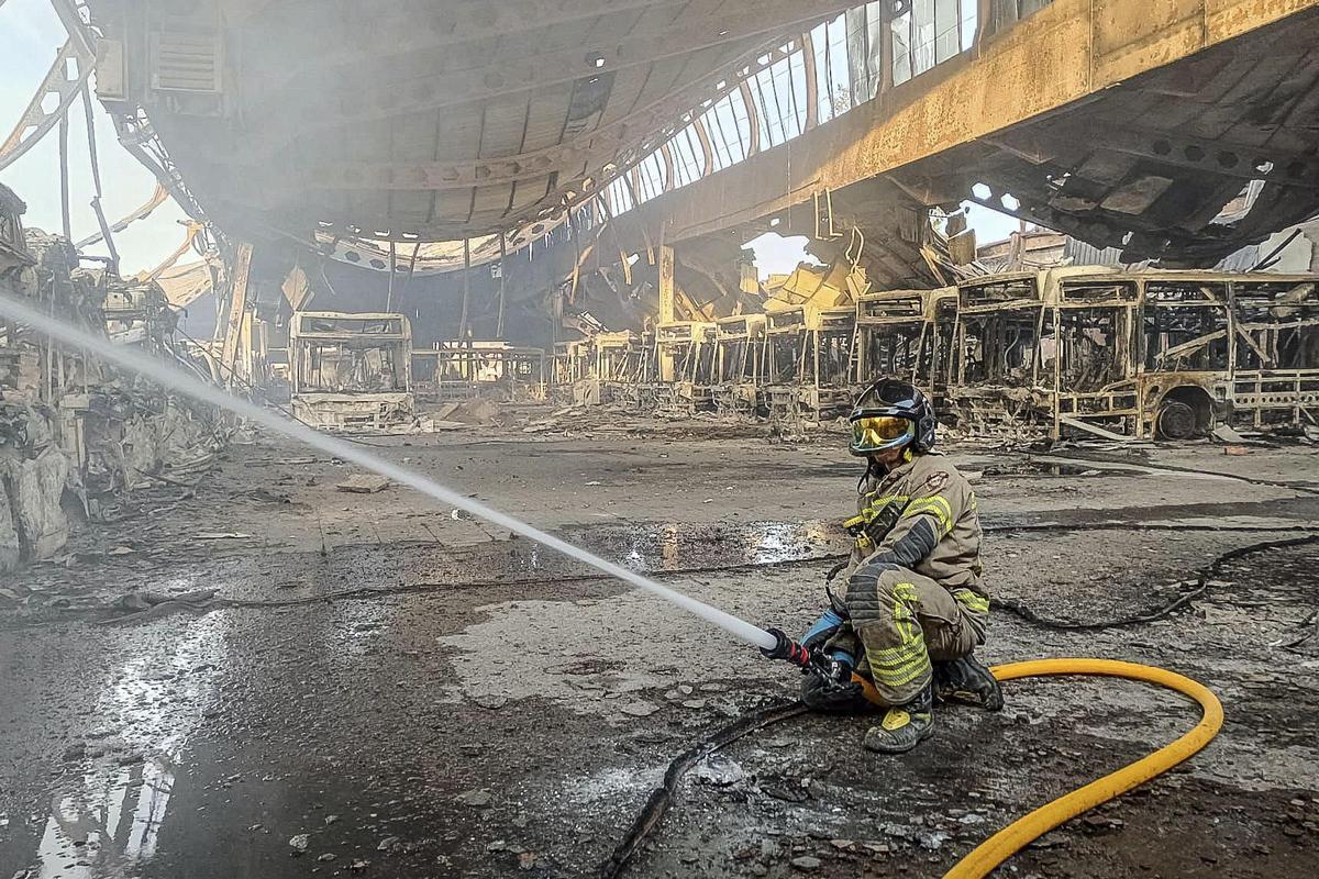 Un bombero trabaja tras el incendio en las cocheras del servicio municipal de autobuses urbanos de Burgos.