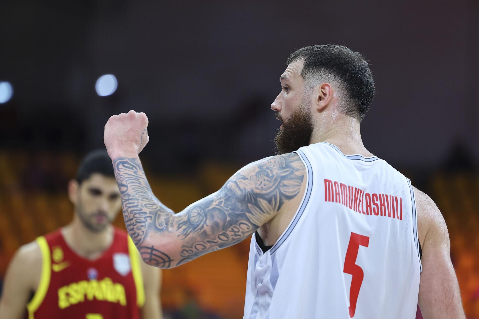 Georgia's Alexander Mamukelashvili celebrates after scoring during the Eurobasket, European Basketball Championship Group C match between Spain and Georgia at the Spyros Kyprianou Arena in Limassol, Cyprus, Thursday, Aug. 28, 2025. (AP Photo/Chara Savvidou)