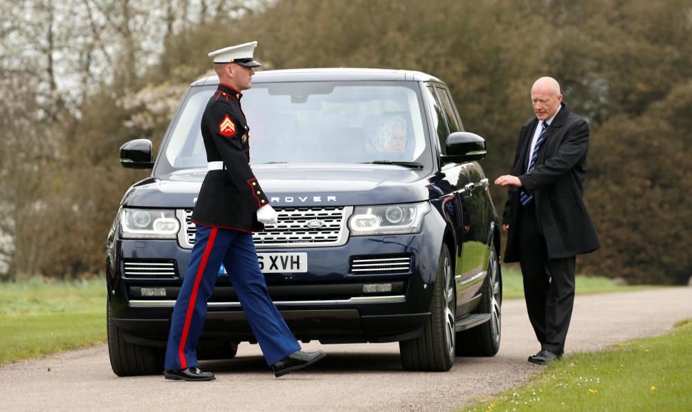 A U.S. Marine passes in front of Queen Elizabeth ...