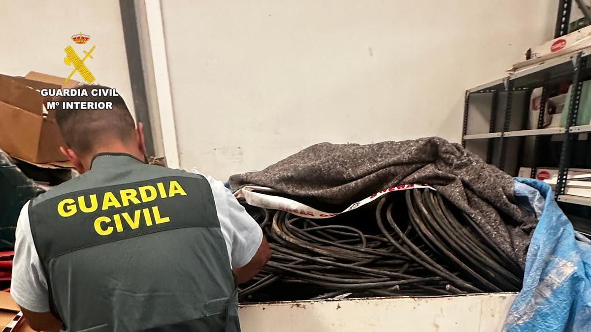 Un agente de la Guardia Civil inspeccionando el cobre robado