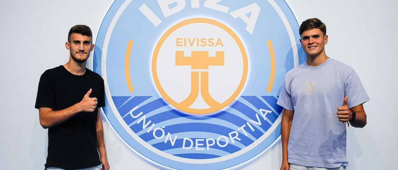 Álvaro García y Martín Pascual posan junto al escudo de la UD Ibiza en el estadio de Can Misses.